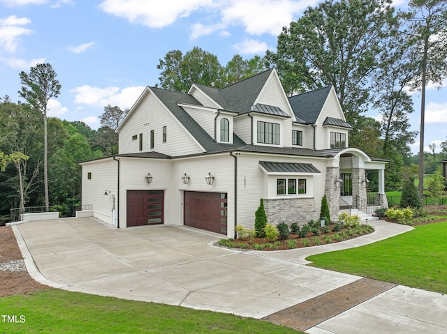 view of front of home with a front yard and a garage