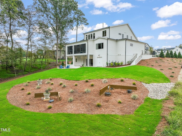 rear view of house featuring a sunroom, a patio area, and a lawn