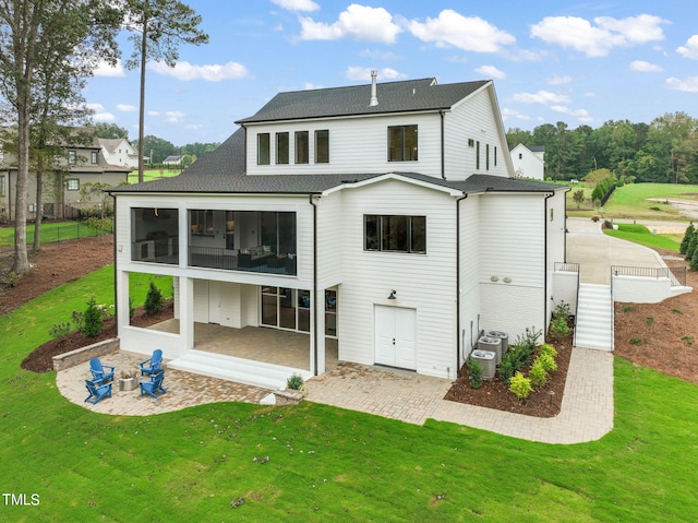 rear view of property featuring a patio and a yard