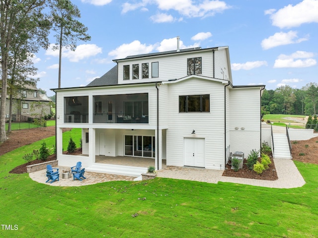 back of property with a sunroom, a patio area, central air condition unit, and a lawn