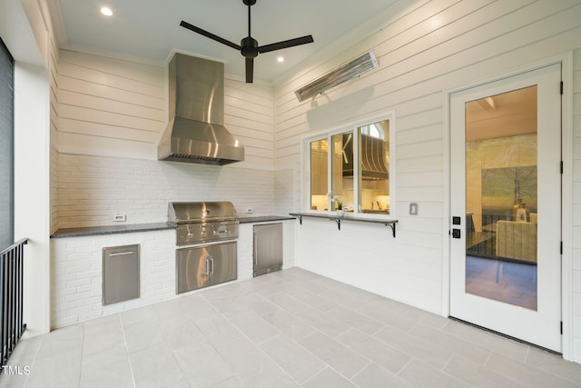 view of patio featuring ceiling fan, area for grilling, and grilling area