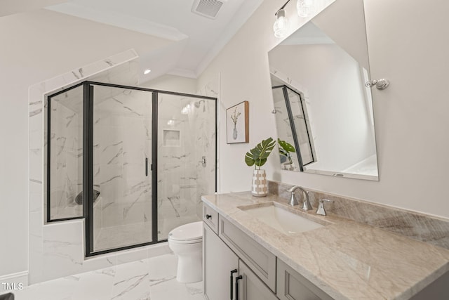 bathroom featuring ornamental molding, vanity, a shower with shower door, and toilet