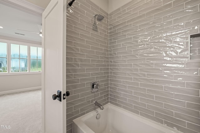 bathroom with tiled shower / bath and crown molding