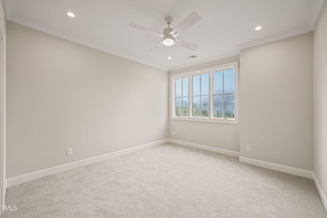 carpeted spare room featuring crown molding and ceiling fan