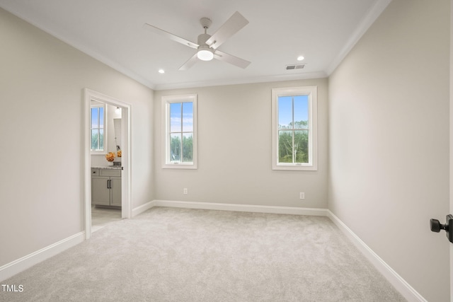 unfurnished bedroom featuring light carpet, connected bathroom, and ceiling fan