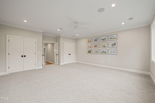 interior space with ornamental molding and ceiling fan