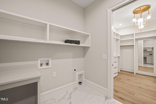 laundry room with washer hookup, a chandelier, hardwood / wood-style floors, and hookup for an electric dryer