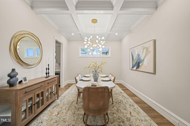 dining space featuring a notable chandelier, hardwood / wood-style flooring, and beam ceiling