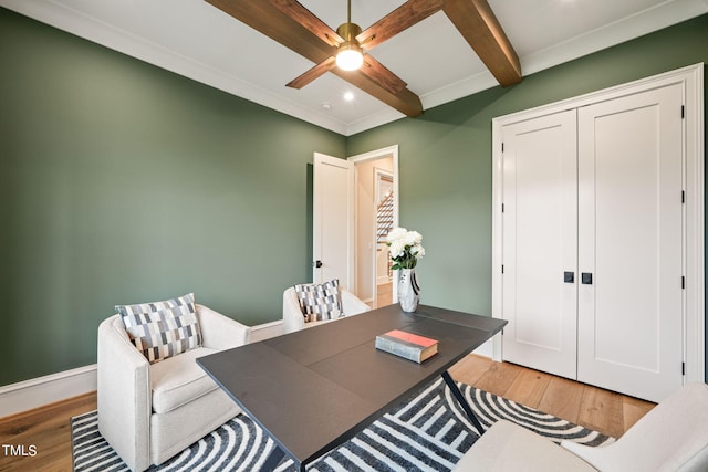 office area with wood-type flooring, beamed ceiling, and ceiling fan