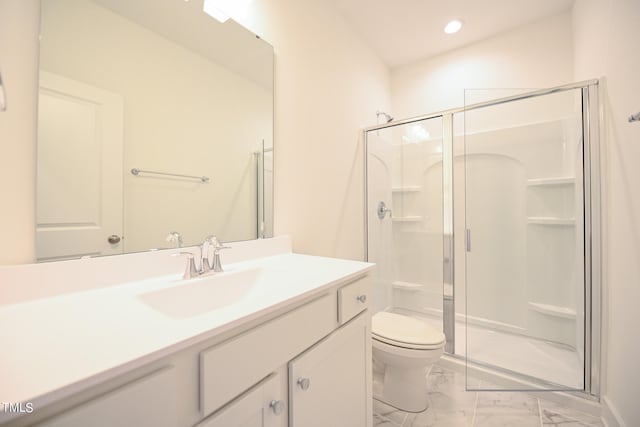 bathroom featuring vanity, toilet, and walk in shower