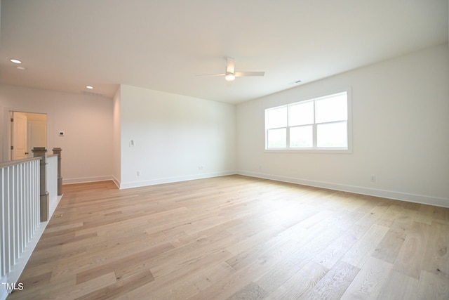 empty room featuring light hardwood / wood-style flooring and ceiling fan