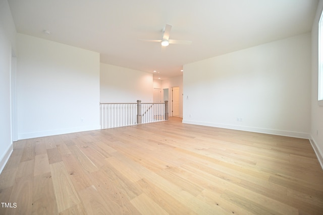 spare room featuring light hardwood / wood-style flooring and ceiling fan