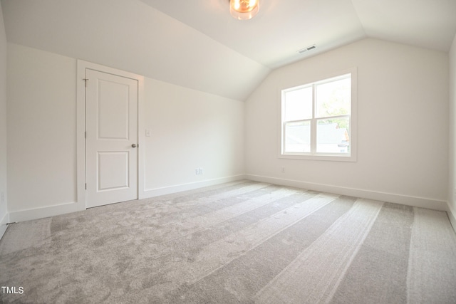 additional living space with carpet floors and lofted ceiling