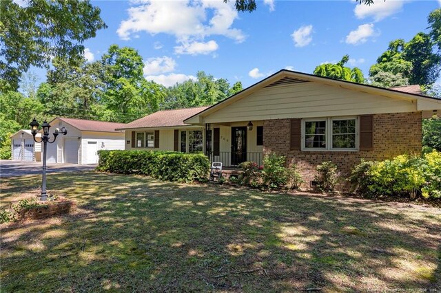 ranch-style home with a garage and a front lawn