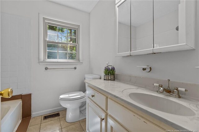 bathroom with a washtub, toilet, oversized vanity, and tile flooring