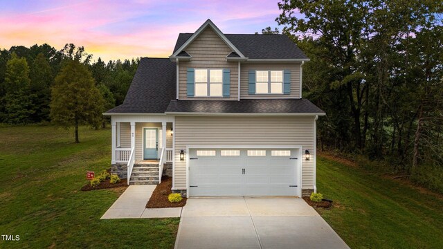 craftsman-style house with a lawn and a garage