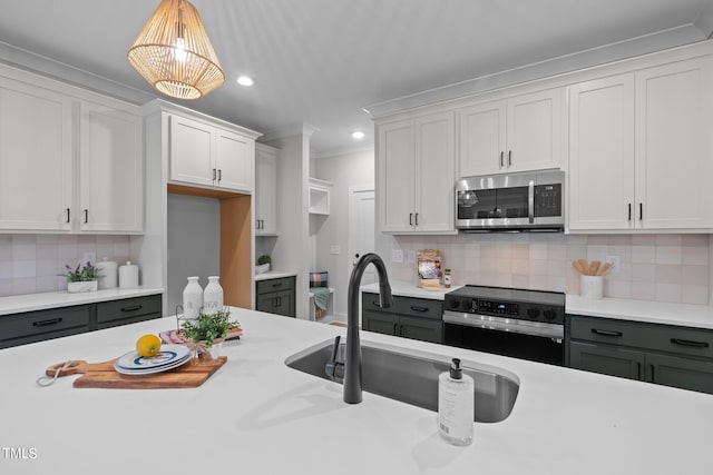 kitchen featuring white cabinets, stainless steel appliances, and tasteful backsplash