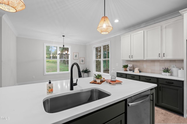 kitchen with white cabinetry, decorative light fixtures, dishwasher, and sink