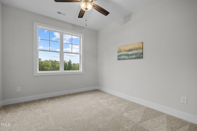 unfurnished room featuring ceiling fan and carpet