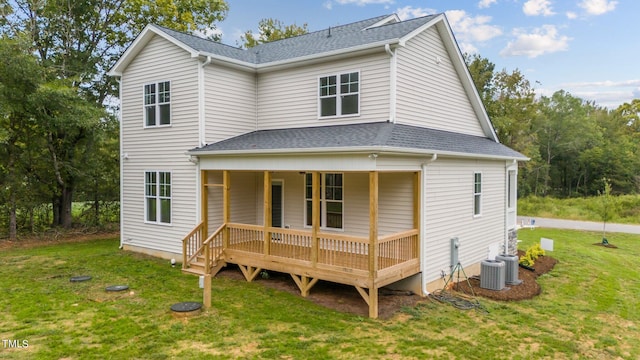 back of property featuring cooling unit, a yard, and a porch