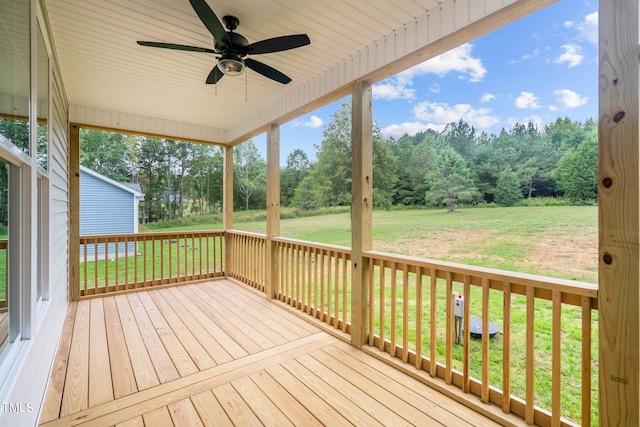 deck with a lawn and ceiling fan