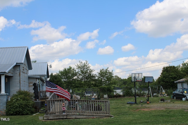 view of yard featuring central AC unit and a wooden deck