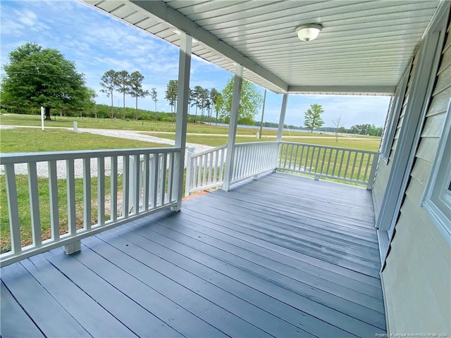 wooden deck featuring a yard