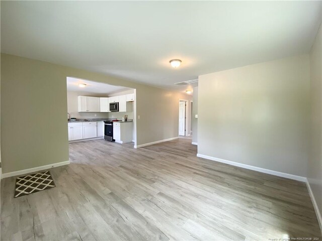 unfurnished living room with wood-type flooring