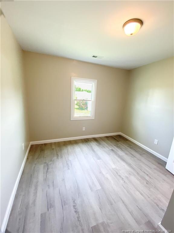 unfurnished room featuring wood-type flooring