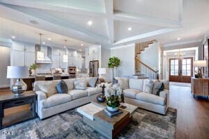 living room featuring hardwood / wood-style floors, beam ceiling, coffered ceiling, and french doors