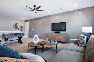 carpeted living room featuring ceiling fan