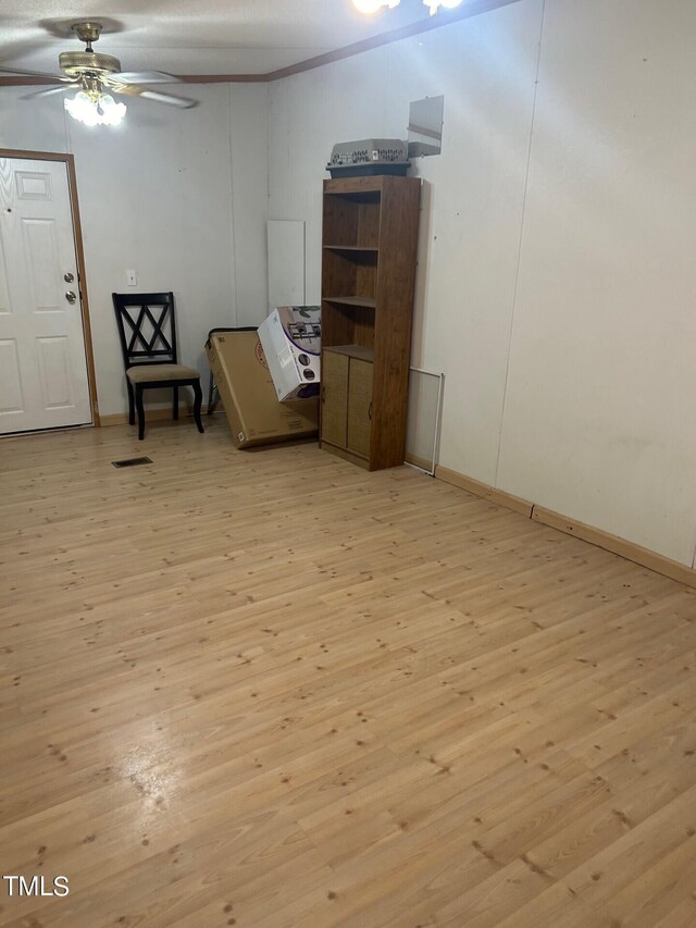 sitting room featuring wood-type flooring and ceiling fan