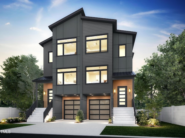 contemporary home featuring a standing seam roof, fence, and metal roof