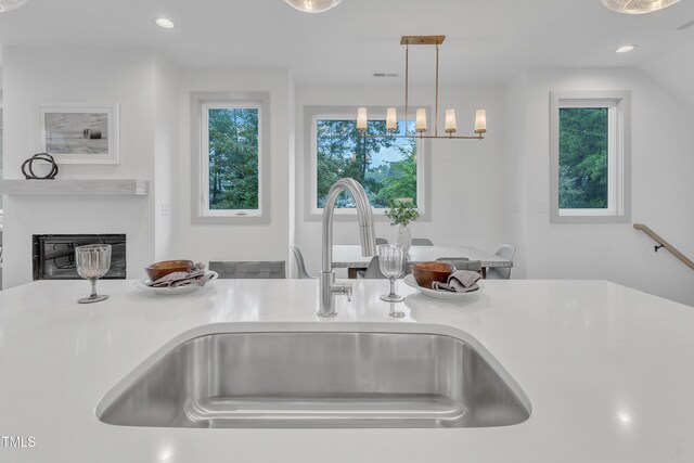 interior details with pendant lighting, light countertops, a sink, and recessed lighting