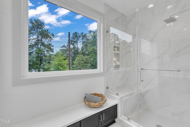 full bathroom featuring a marble finish shower