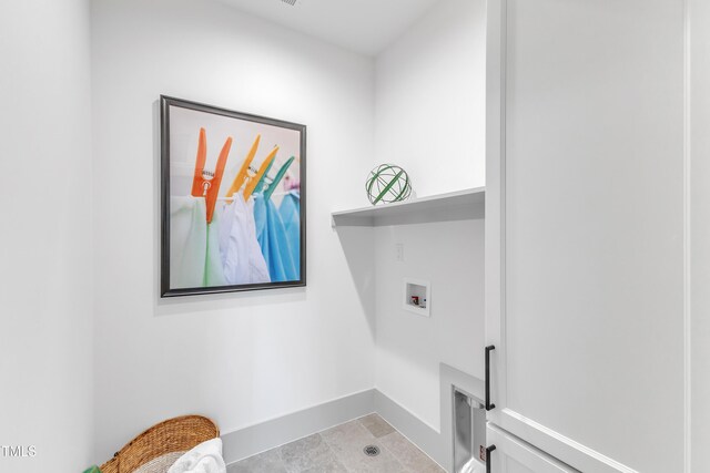 washroom with laundry area, baseboards, and washer hookup