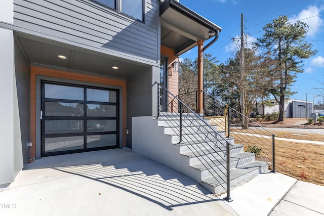 entrance to property with a garage and concrete driveway