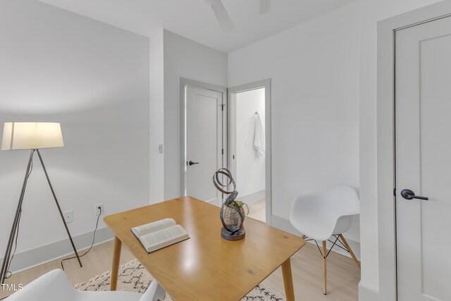 office area featuring light wood-type flooring, baseboards, and a ceiling fan