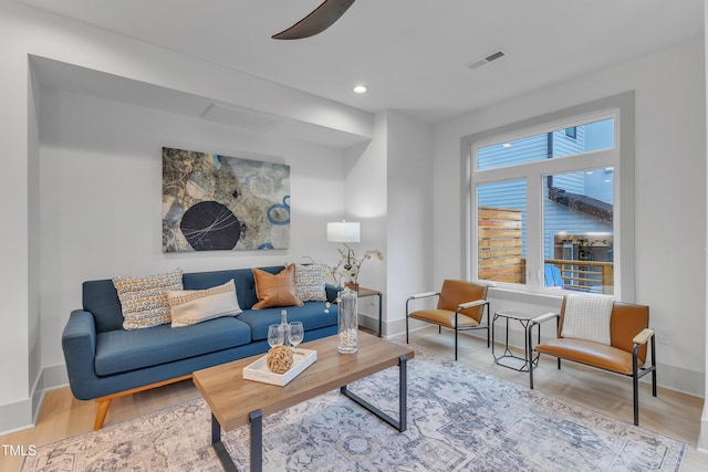 living area with baseboards, visible vents, ceiling fan, wood finished floors, and recessed lighting