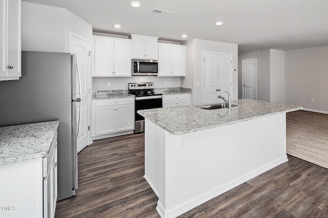 kitchen with a center island with sink, white cabinets, sink, and stainless steel appliances