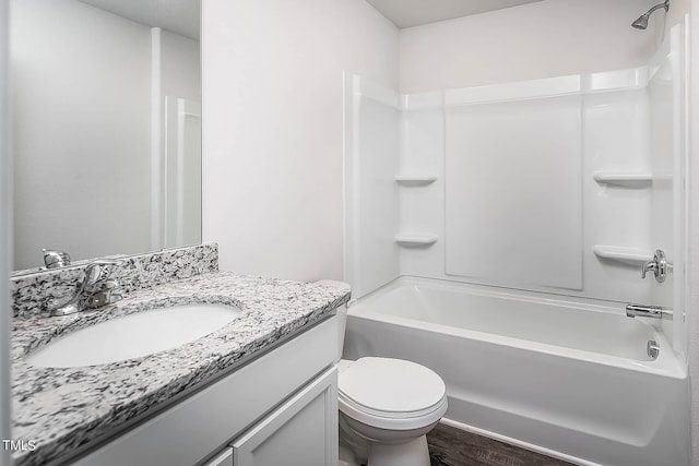 full bathroom featuring bathtub / shower combination, wood-type flooring, vanity, and toilet