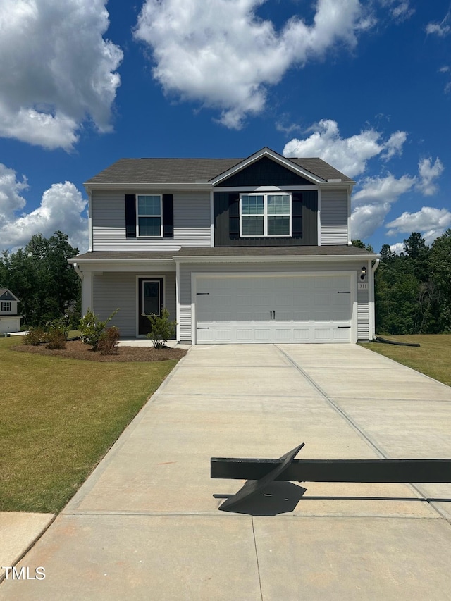 view of front of home with a garage and a front yard