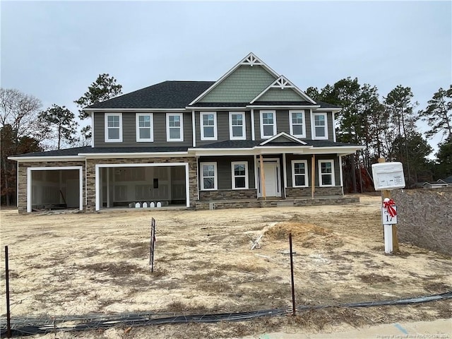 view of front of property featuring covered porch and a garage