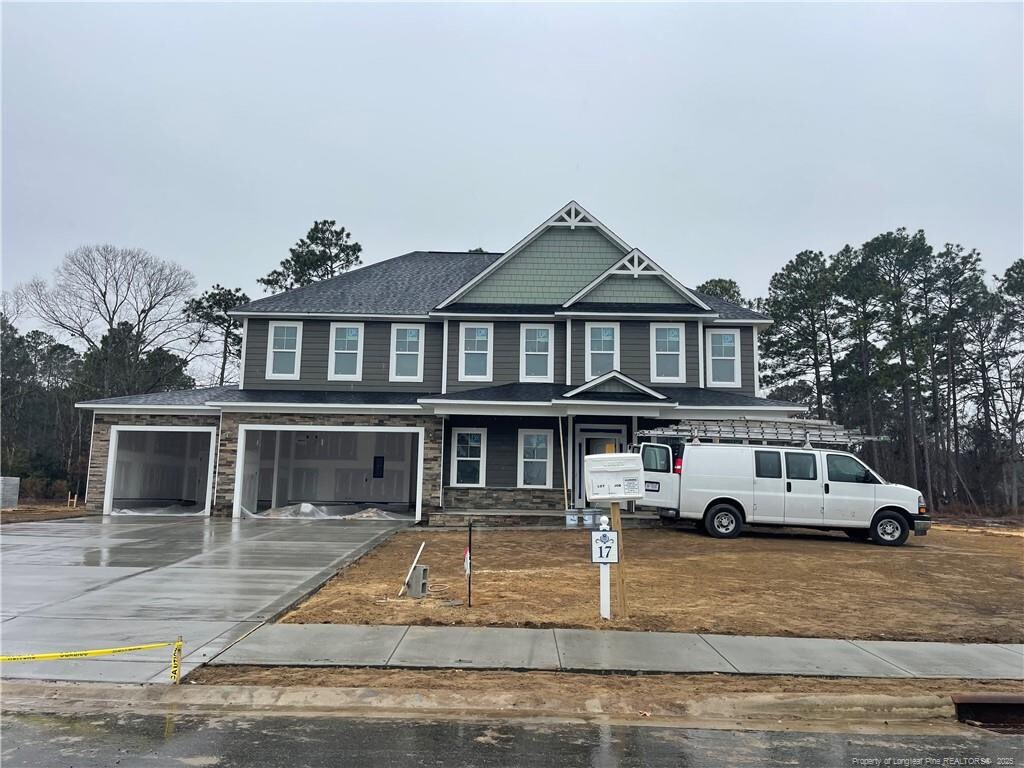 3047 Cragburn Pl, Fayetteville, NC 28306 - view of front of property featuring stone siding, a garage, and concrete driveway