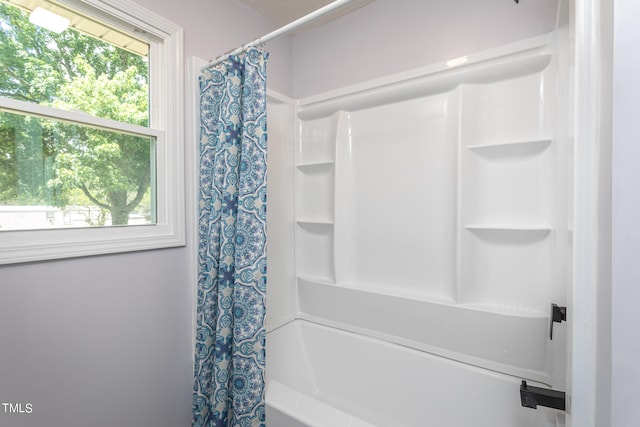 bathroom featuring shower / tub combo with curtain