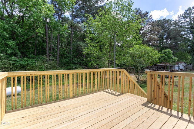 wooden deck featuring a yard