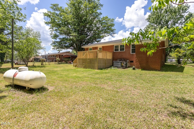 view of yard with a wooden deck and central AC