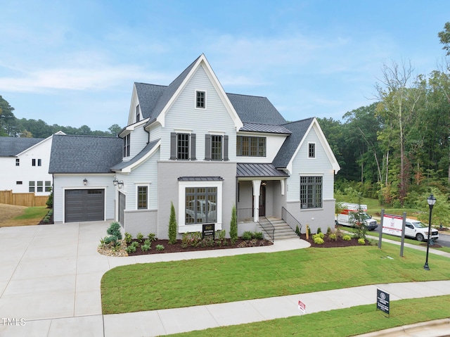 modern farmhouse style home featuring a front lawn and a garage