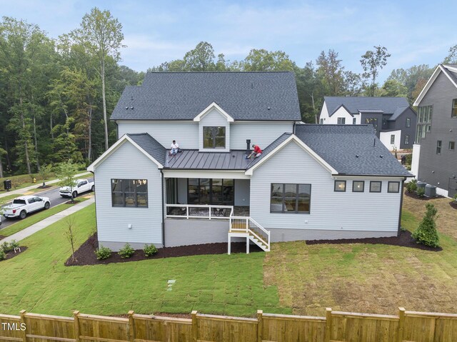 back of house with a lawn