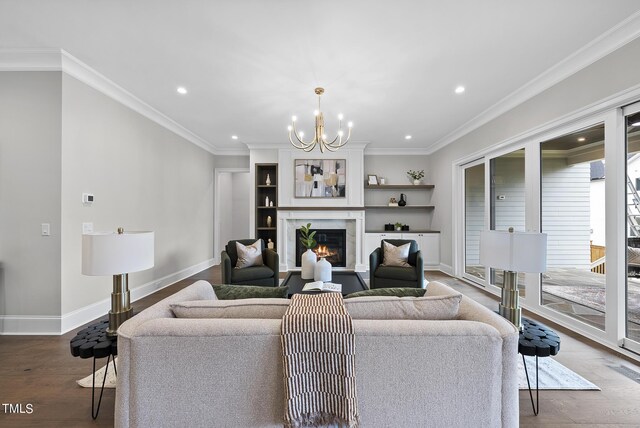 living room featuring ornamental molding, an inviting chandelier, and hardwood / wood-style flooring